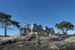 The rocky coastline on which the house sits.